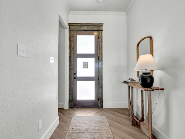 entrance foyer with crown molding and a healthy amount of sunlight