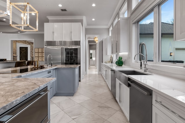 kitchen with white cabinetry, gray cabinets, hanging light fixtures, crown molding, and black appliances