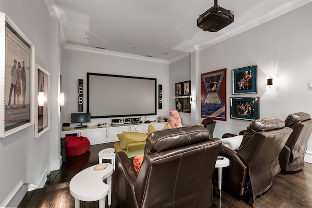 cinema featuring dark wood-type flooring and crown molding