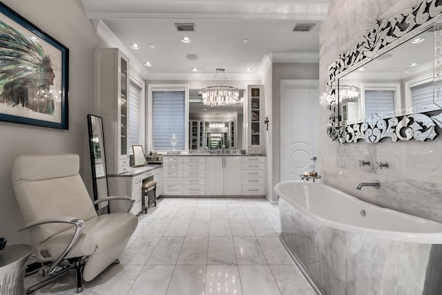 bathroom featuring vanity, ornamental molding, a chandelier, and a relaxing tiled tub