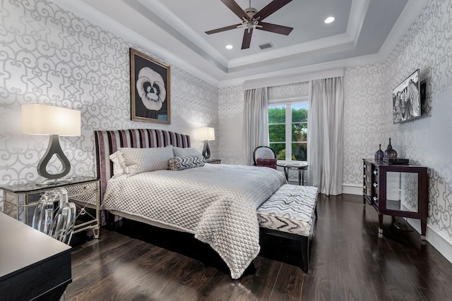 bedroom with ceiling fan, dark hardwood / wood-style floors, ornamental molding, and a raised ceiling