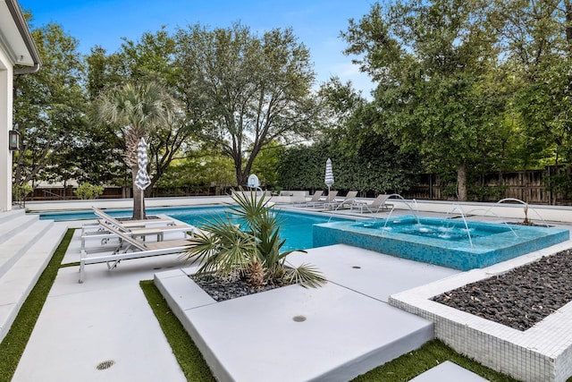 view of pool with pool water feature, a patio area, and a hot tub