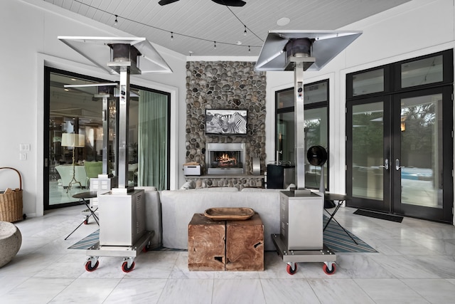 view of patio featuring ceiling fan and a fireplace