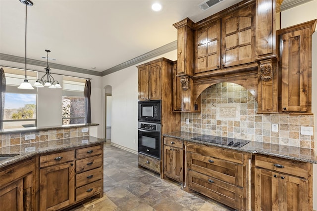 kitchen featuring black appliances, decorative light fixtures, dark stone counters, decorative backsplash, and ornamental molding