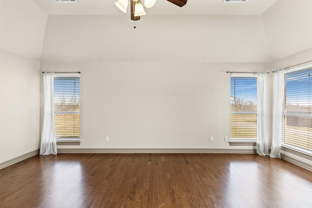 spare room featuring a raised ceiling, ceiling fan, dark hardwood / wood-style floors, and lofted ceiling