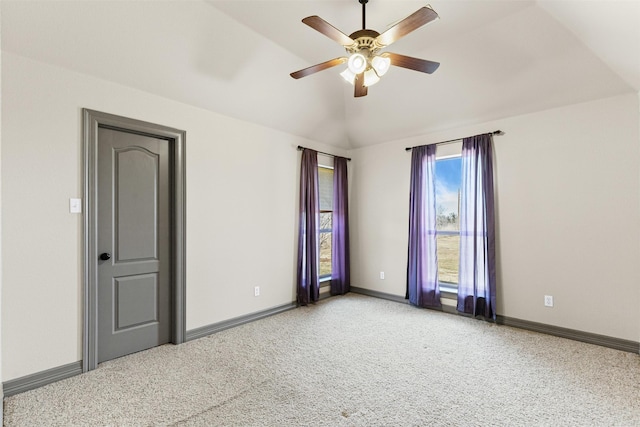 empty room with carpet, ceiling fan, and lofted ceiling