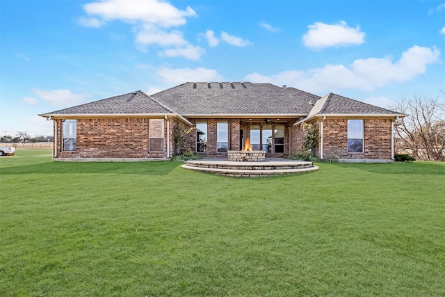 rear view of property with a lawn and a patio area