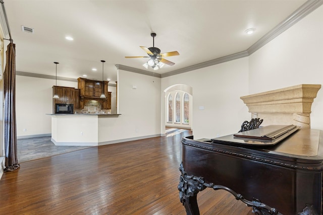 miscellaneous room with ceiling fan, dark hardwood / wood-style floors, and crown molding