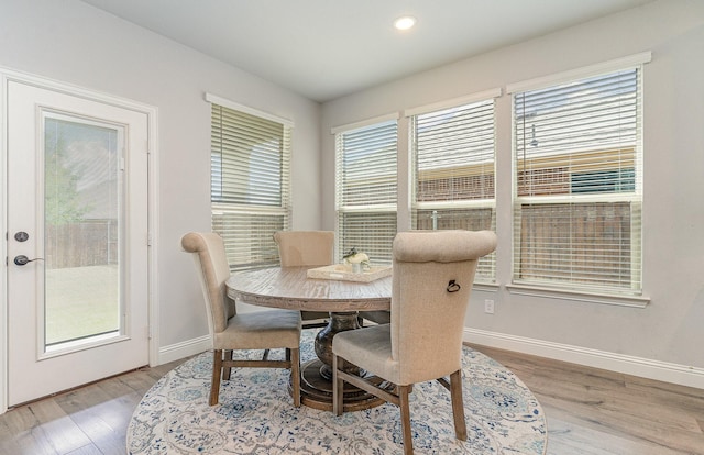 dining space with hardwood / wood-style flooring