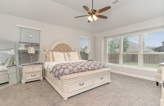 bedroom with ceiling fan, lofted ceiling, and light carpet