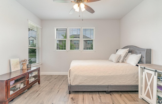 bedroom with light wood-type flooring and ceiling fan