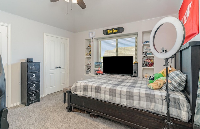 carpeted bedroom featuring ceiling fan and a closet