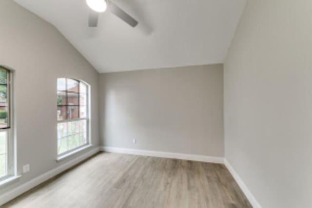 unfurnished room with ceiling fan, lofted ceiling, and light hardwood / wood-style floors