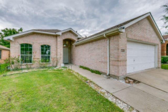 single story home featuring a garage and a front yard