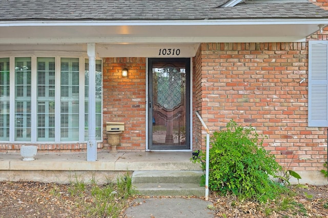 view of exterior entry with covered porch