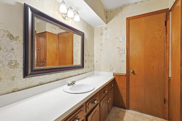 bathroom with tile patterned flooring, vanity, and wooden walls