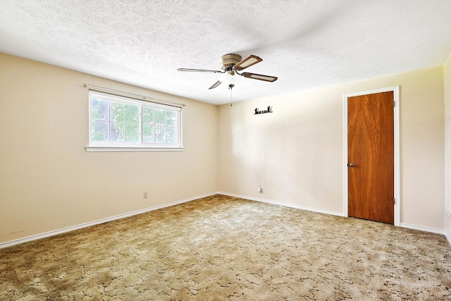 carpeted spare room with ceiling fan and a textured ceiling