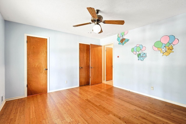 unfurnished bedroom featuring light wood-type flooring, ceiling fan, and a textured ceiling