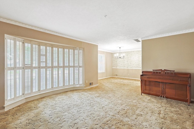 carpeted spare room featuring an inviting chandelier and crown molding