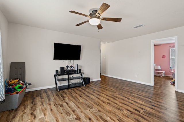 living room featuring dark hardwood / wood-style floors and ceiling fan