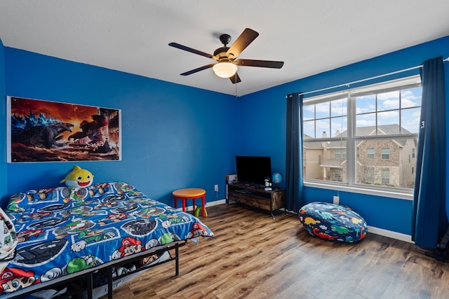 bedroom featuring hardwood / wood-style floors and ceiling fan