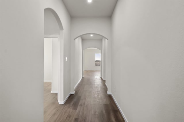 corridor with hardwood / wood-style flooring