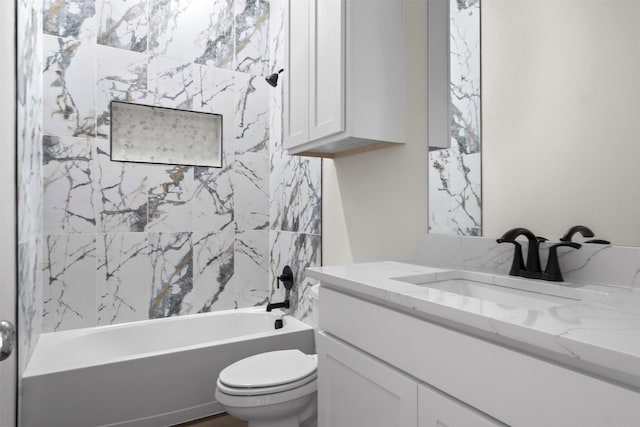 full bathroom featuring toilet, vanity, and tiled shower / bath