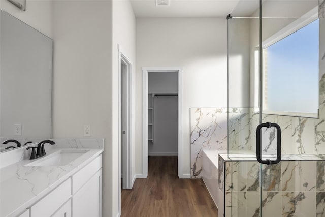 bathroom featuring vanity, a shower with door, and hardwood / wood-style flooring