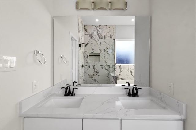 bathroom featuring walk in shower and vanity