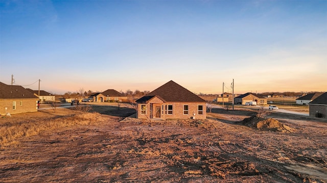 view of back house at dusk