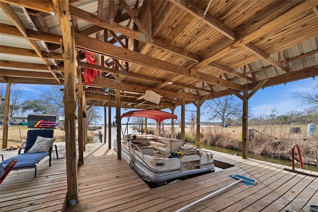 wooden terrace with a dock and a water view