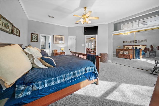 bedroom featuring ceiling fan, a closet, carpet, and crown molding