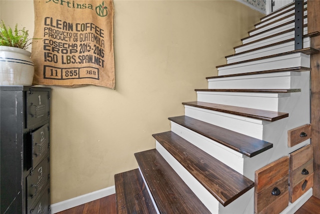 stairs featuring hardwood / wood-style flooring