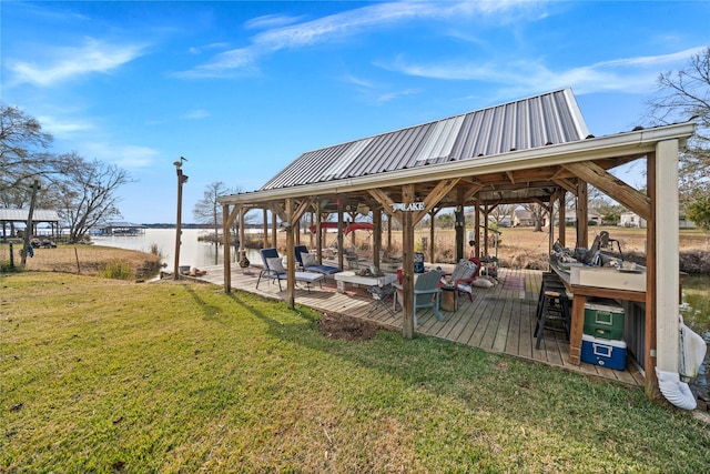 dock area featuring a water view, a lawn, and a gazebo