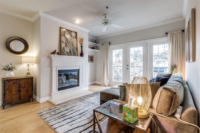 living room featuring ceiling fan, crown molding, and light hardwood / wood-style floors