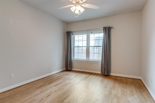 spare room featuring ceiling fan and light hardwood / wood-style floors