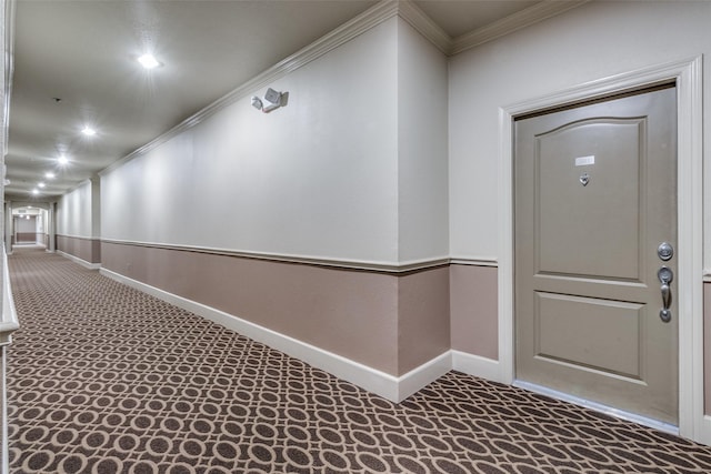 hallway featuring carpet floors and crown molding