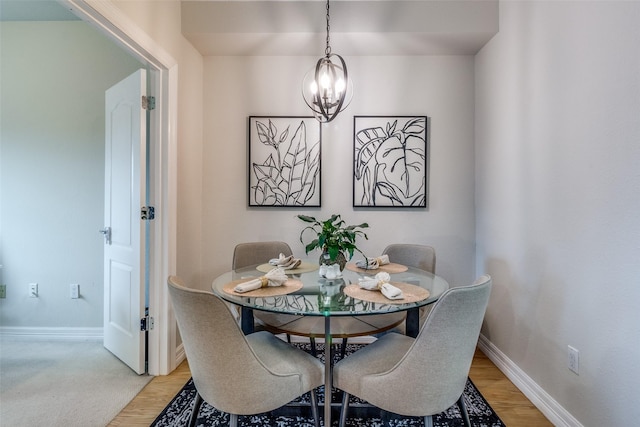 dining room featuring light hardwood / wood-style floors and an inviting chandelier