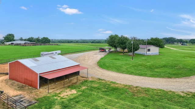 view of property's community featuring a yard and a rural view