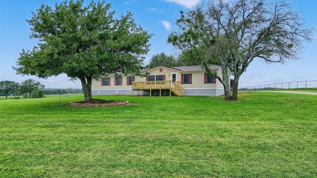 view of front of home featuring a deck and a front yard