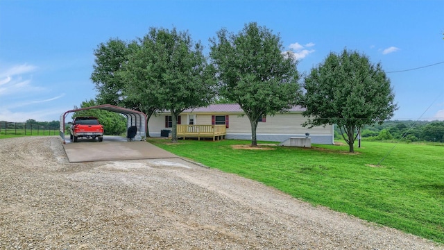 single story home featuring a front yard, a deck, and a carport