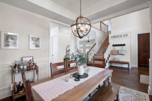 dining area featuring dark hardwood / wood-style floors, ceiling fan with notable chandelier, and crown molding