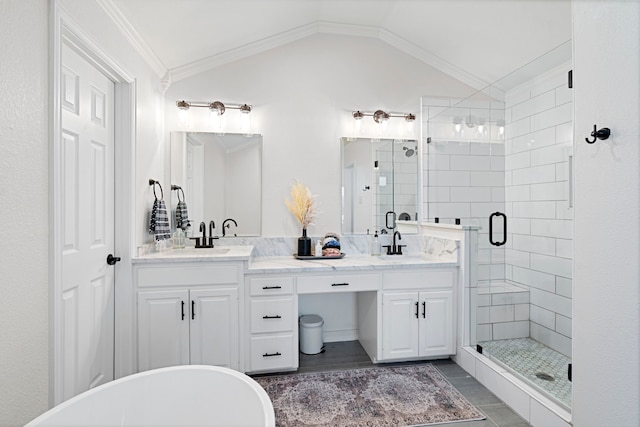 bathroom with vaulted ceiling, ornamental molding, plus walk in shower, and vanity