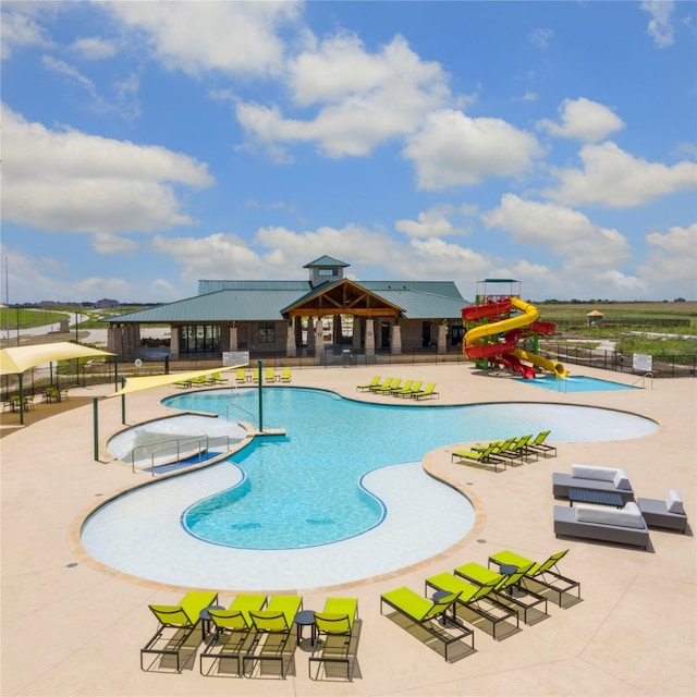 view of pool with a playground, a patio area, a gazebo, and a water slide