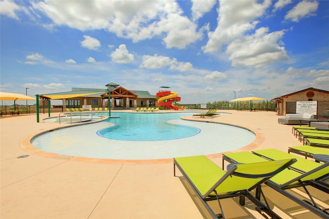 view of swimming pool with a grill and a patio