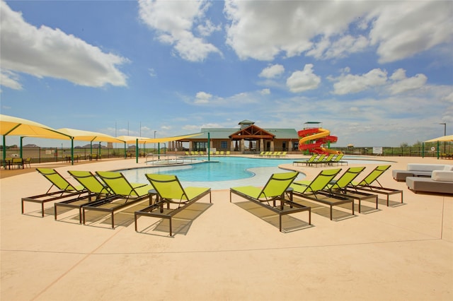 view of pool with a patio area and a playground