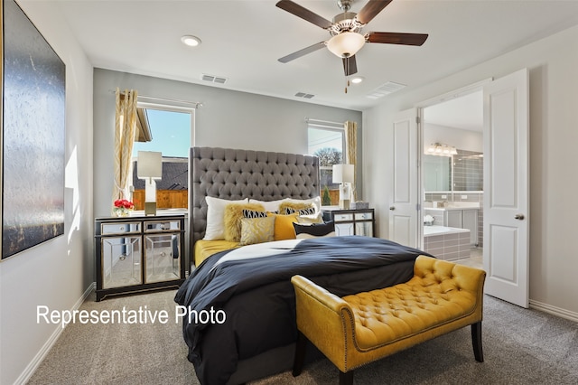 carpeted bedroom featuring ceiling fan and ensuite bathroom