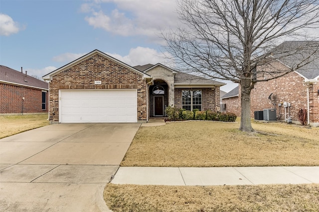 view of front of home featuring a garage, a front lawn, and central air condition unit