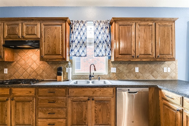 kitchen featuring appliances with stainless steel finishes, tasteful backsplash, and sink