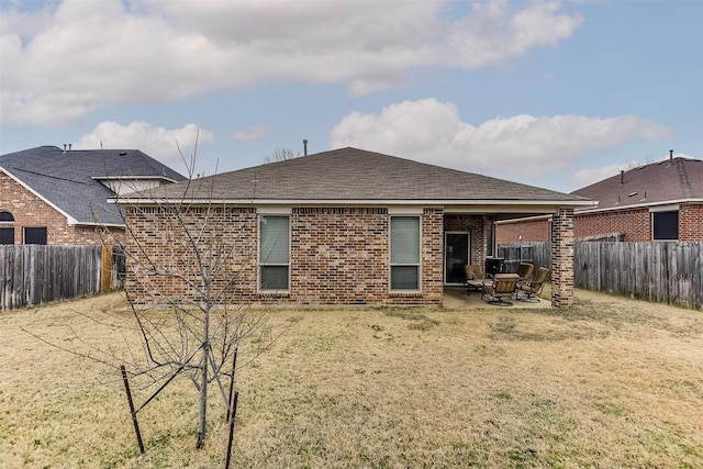 rear view of house with a patio area and a yard